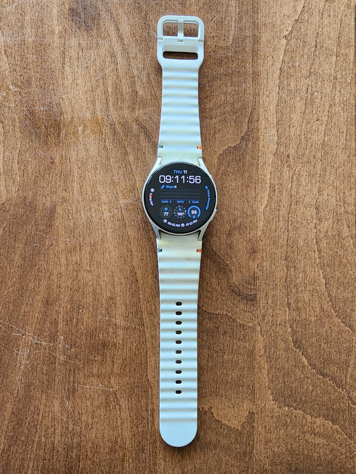 Samsung Galaxy Watch 7 40mm on a wooden table, used for alarms and timers.